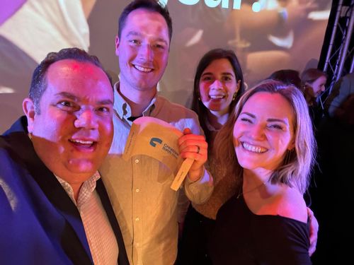 Selfie of four people celebrating winning an award.