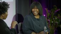 Closeup of Joan Armatrading being interviewed on stage.